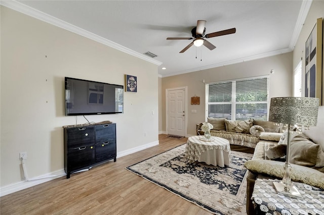 living room with ceiling fan, wood finished floors, visible vents, baseboards, and ornamental molding