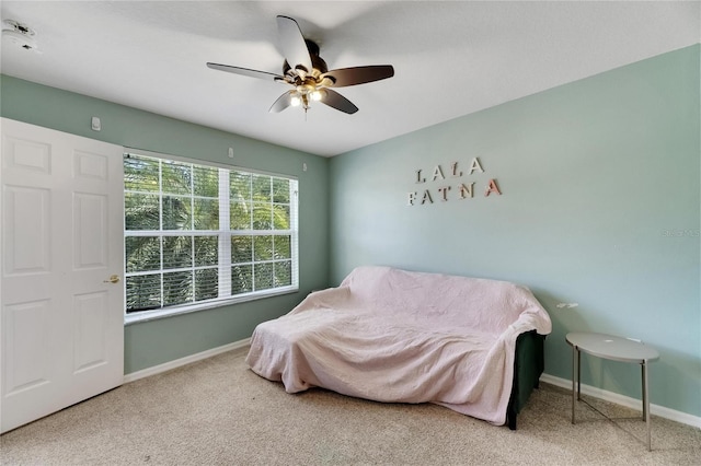 carpeted bedroom featuring ceiling fan and baseboards