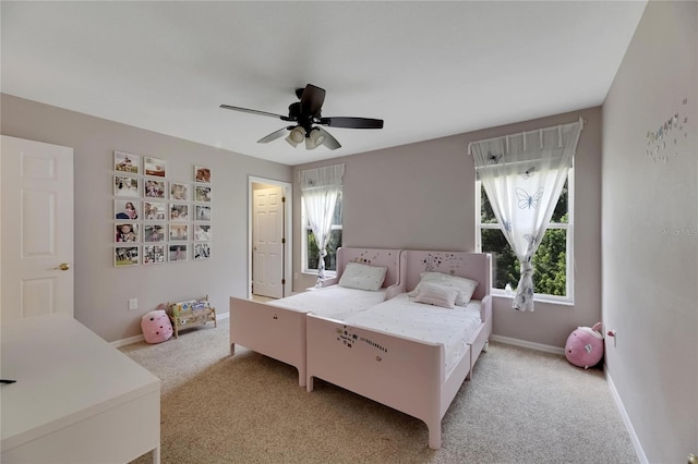 bedroom with baseboards, a ceiling fan, and light colored carpet