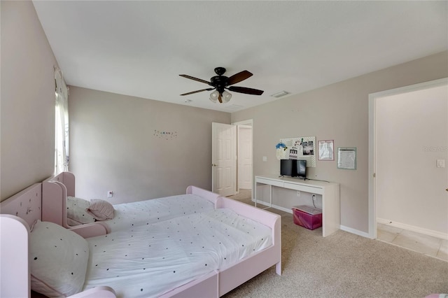 bedroom featuring light colored carpet, ceiling fan, visible vents, and baseboards