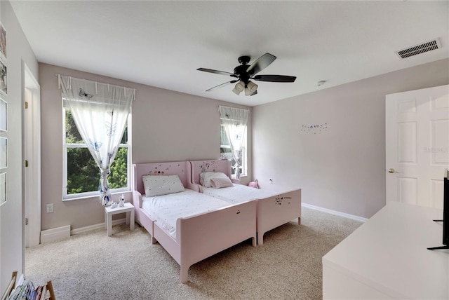 bedroom with visible vents, ceiling fan, light carpet, and baseboards