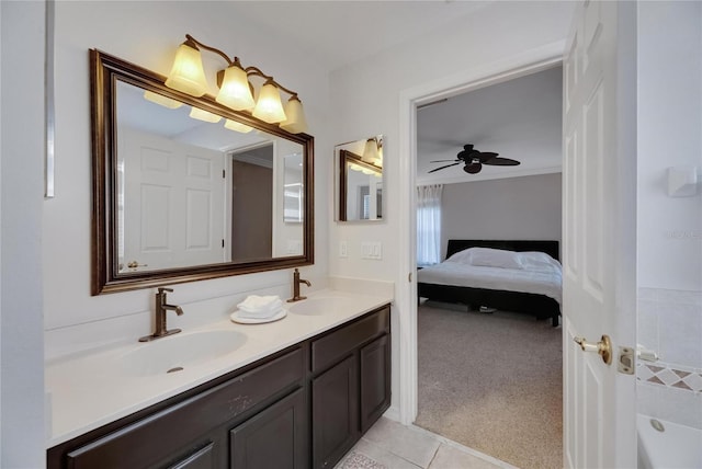 ensuite bathroom featuring double vanity, ensuite bath, crown molding, and a sink