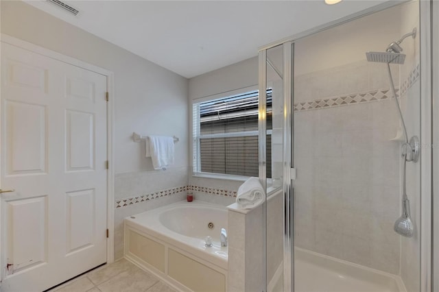 full bath featuring a garden tub, tile patterned flooring, visible vents, and a shower stall