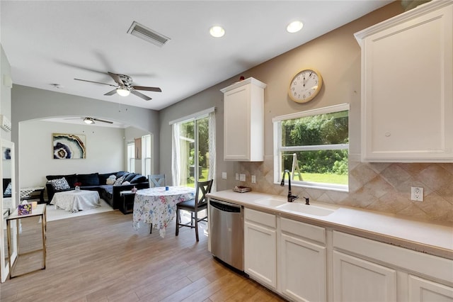 kitchen with a sink, visible vents, white cabinetry, light countertops, and stainless steel dishwasher