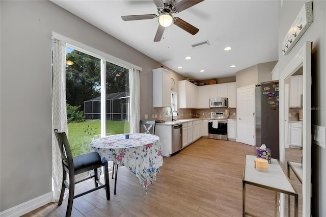 kitchen with stainless steel appliances, light countertops, visible vents, and white cabinets