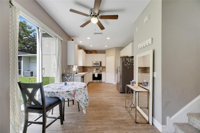 dining space with recessed lighting, visible vents, baseboards, stairs, and light wood finished floors