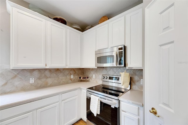 kitchen featuring white cabinets, appliances with stainless steel finishes, light countertops, and decorative backsplash