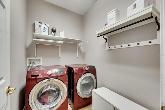 laundry room featuring washing machine and dryer and laundry area