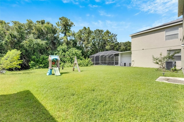 view of yard featuring central AC unit and a playground