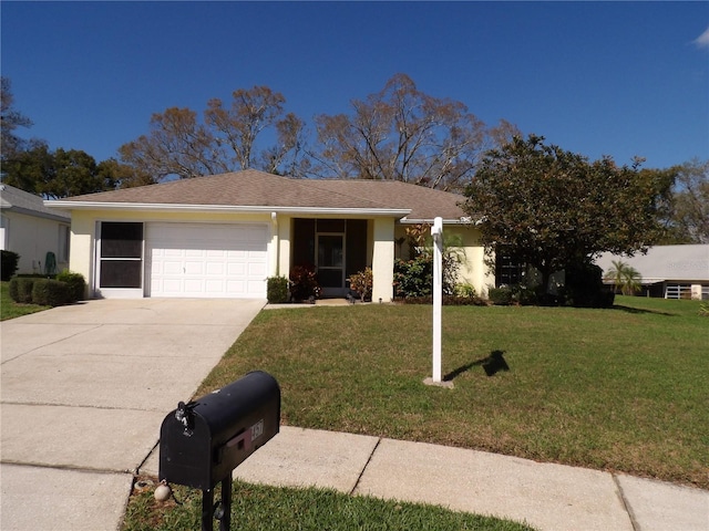 ranch-style home with a garage, a front yard, driveway, and stucco siding