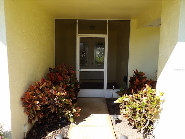 doorway to property with french doors and stucco siding