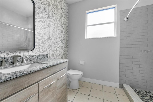 3616 Cypress Meadows Rd, Tampa, FL 33624 - bathroom with vanity, a tile shower, toilet, tile patterned floors, and baseboards