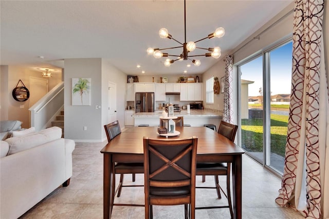 dining room featuring an inviting chandelier, stairs, baseboards, and recessed lighting