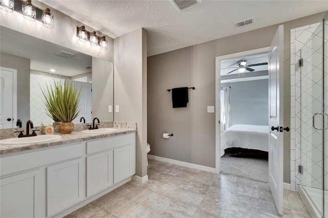 bathroom featuring connected bathroom, visible vents, and a sink