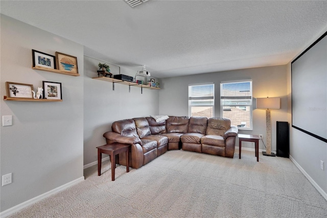 living room with light carpet, baseboards, and a textured ceiling