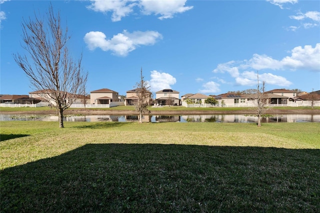 view of yard with a water view and a residential view