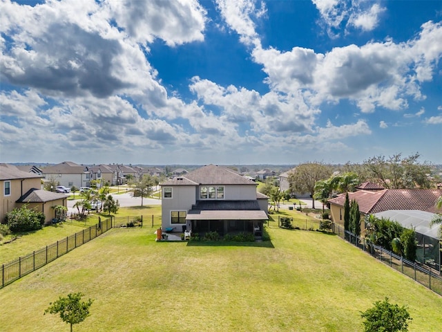 view of yard featuring a fenced backyard and a residential view