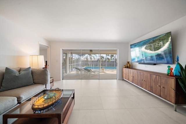 living room with a sunroom and light tile patterned floors