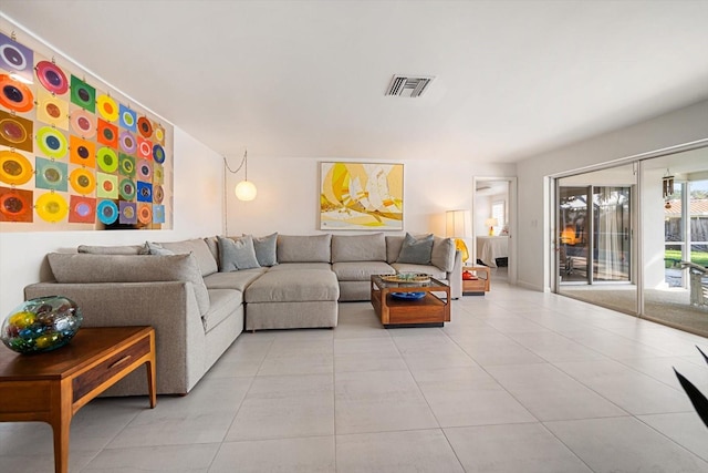 living area with light tile patterned floors and visible vents