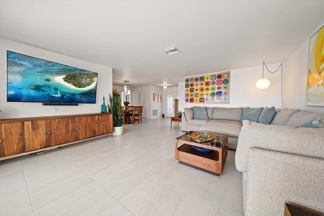 living room featuring tile patterned flooring and visible vents