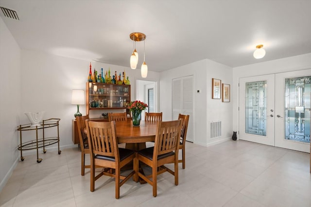 dining room with baseboards, visible vents, and french doors