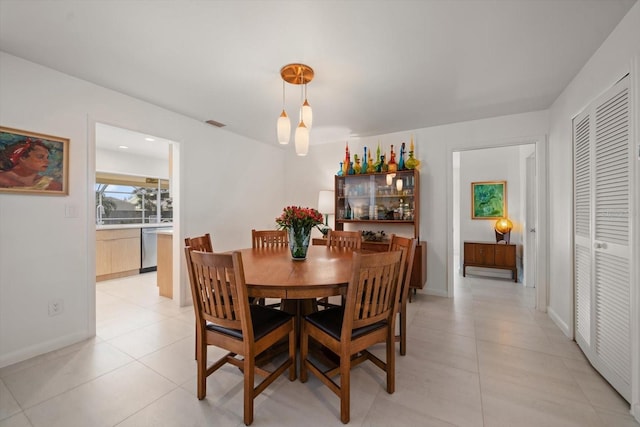 dining room with visible vents, baseboards, and light tile patterned flooring