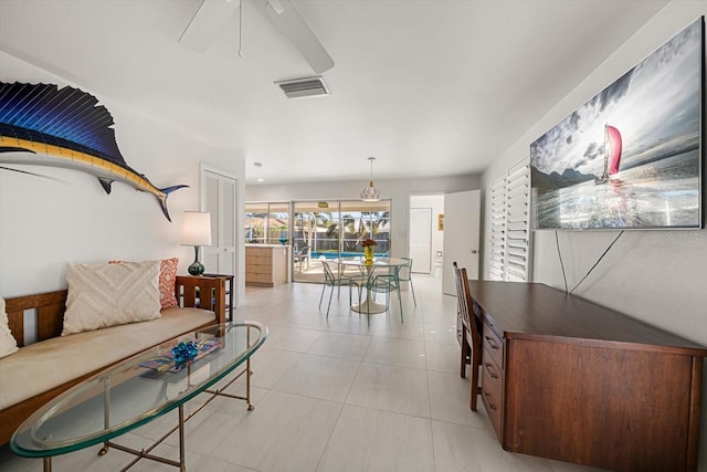 interior space featuring light tile patterned floors, ceiling fan, and visible vents