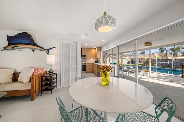 dining room featuring a healthy amount of sunlight, light tile patterned floors, and recessed lighting