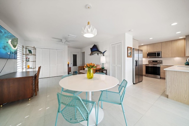 dining area featuring light tile patterned flooring, a ceiling fan, and recessed lighting