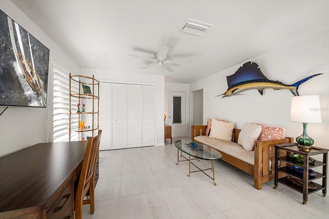 living area featuring visible vents and a ceiling fan