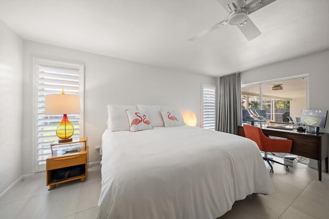 bedroom featuring a ceiling fan, baseboards, and light tile patterned floors