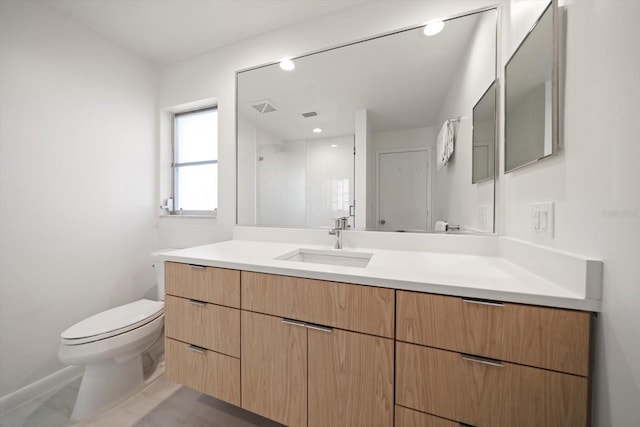 bathroom with a stall shower, visible vents, vanity, and toilet