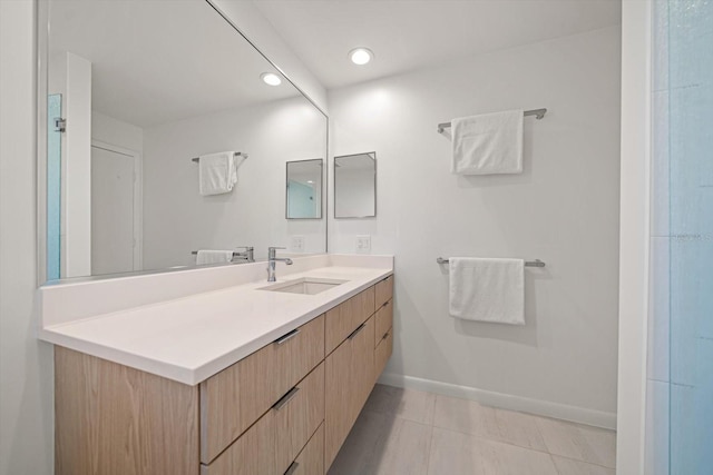 bathroom featuring recessed lighting, tile patterned floors, vanity, and baseboards