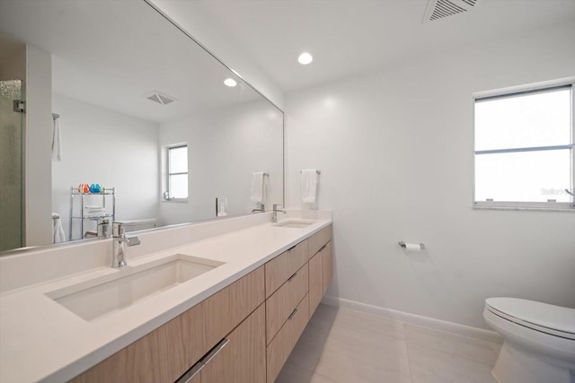 full bath with visible vents, a sink, and double vanity