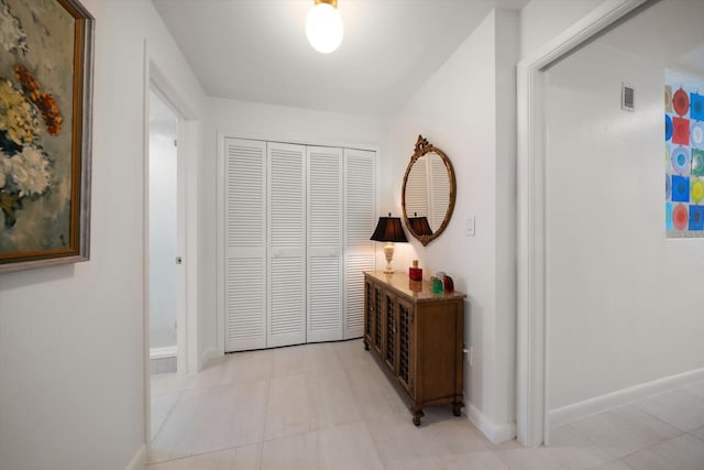 hall featuring visible vents and baseboards