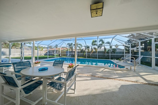 view of swimming pool with a fenced in pool, glass enclosure, a patio, and a fenced backyard