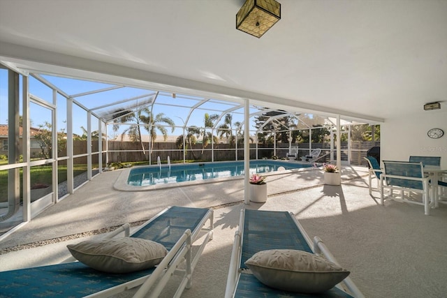 view of pool with a fenced in pool, glass enclosure, a patio area, and a fenced backyard