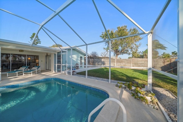 pool featuring a yard, a lanai, a fenced backyard, and a patio