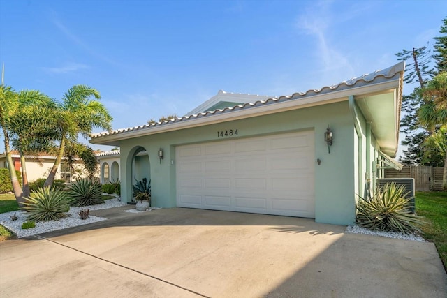 view of front facade featuring a garage, concrete driveway, and stucco siding