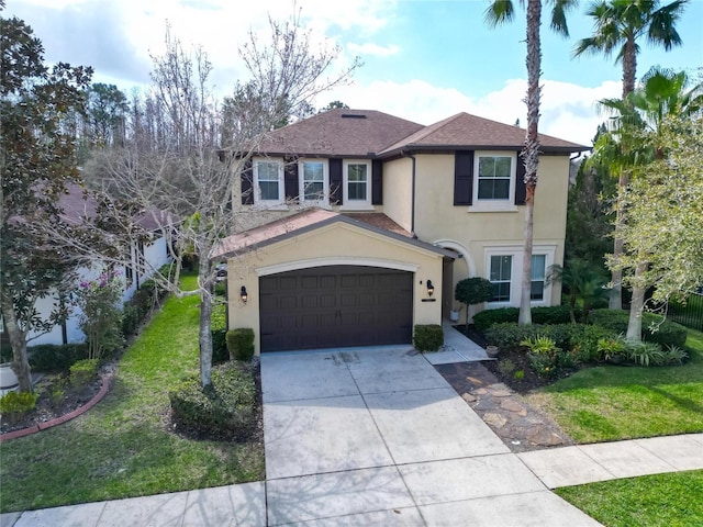 view of front of home with a shingled roof, a front yard, concrete driveway, and stucco siding