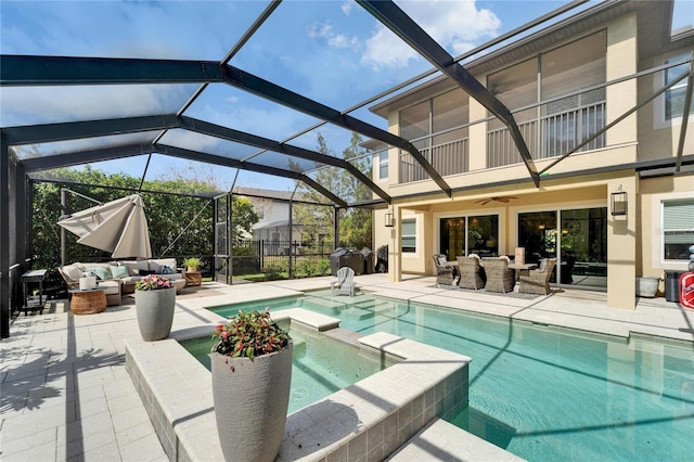 view of pool featuring a lanai, a patio area, and an outdoor living space