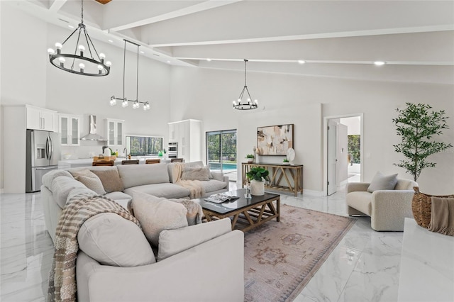 living area with vaulted ceiling with beams, an inviting chandelier, marble finish floor, and recessed lighting