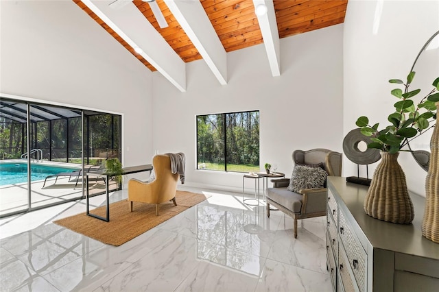 sitting room with marble finish floor, wooden ceiling, high vaulted ceiling, and beam ceiling