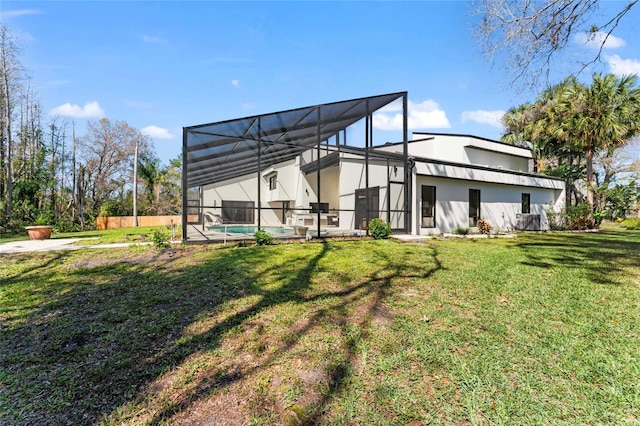 back of house featuring a fenced in pool, a lanai, a yard, and stucco siding