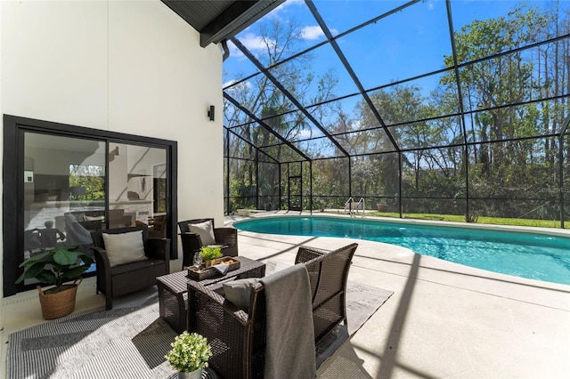 pool featuring glass enclosure and a patio