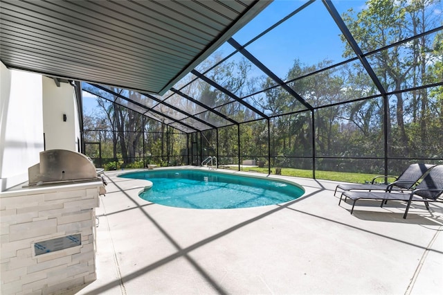 outdoor pool featuring a lanai, a patio area, and area for grilling