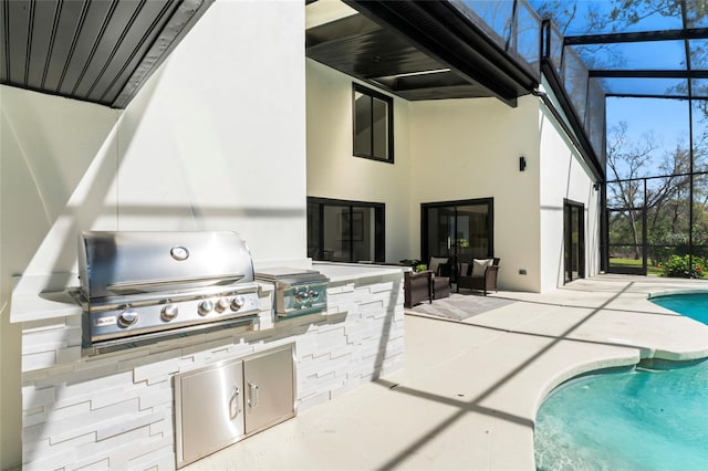 view of patio / terrace featuring glass enclosure, area for grilling, and an outdoor pool