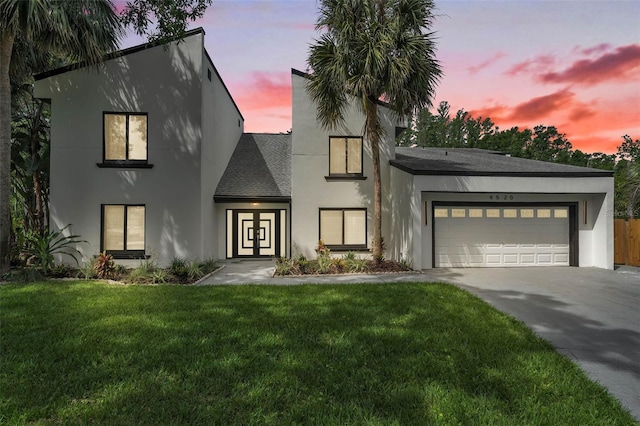 4520 Pine Hollow Dr, Tampa, FL 33624 - view of front of house with concrete driveway, an attached garage, a lawn, stucco siding, and roof with shingles