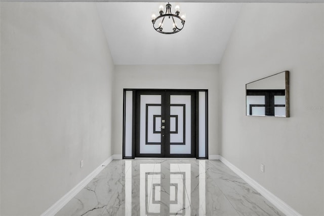 4520 Pine Hollow Dr, Tampa, FL 33624 - doorway featuring marble tiled flooring, a chandelier, baseboards, and vaulted ceiling