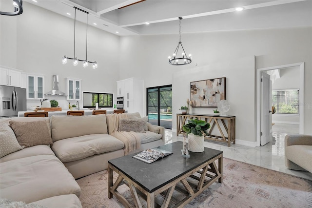 4520 Pine Hollow Dr, Tampa, FL 33624 - living area with a towering ceiling, light marble finish floors, a chandelier, plenty of natural light, and recessed lighting